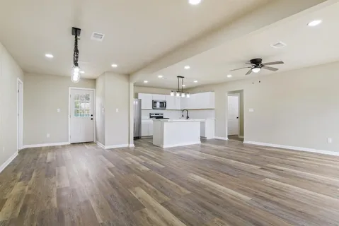 a view of a kitchen with a sink and a refrigerator