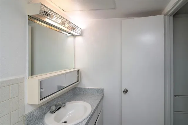 a bathroom with a sink and mirror