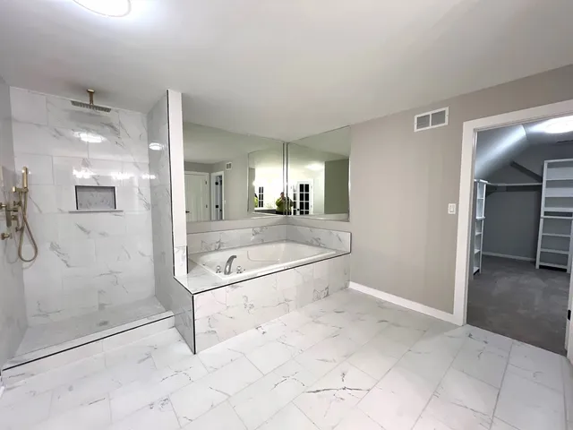 a bathroom with a double vanity sink toilet mirror and bathtub
