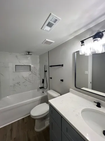 a bedroom with a bed and a lamp