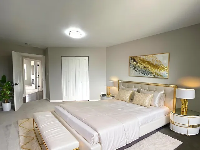 a bedroom with a bed and a lamp