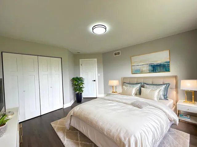 a view of a hallway with wooden floor and stairs