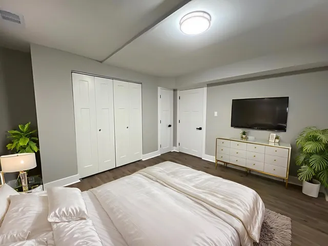 an empty room with wooden floor and window