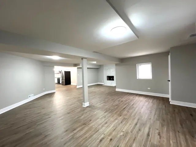 a kitchen with stainless steel appliances a refrigerator and wooden floor