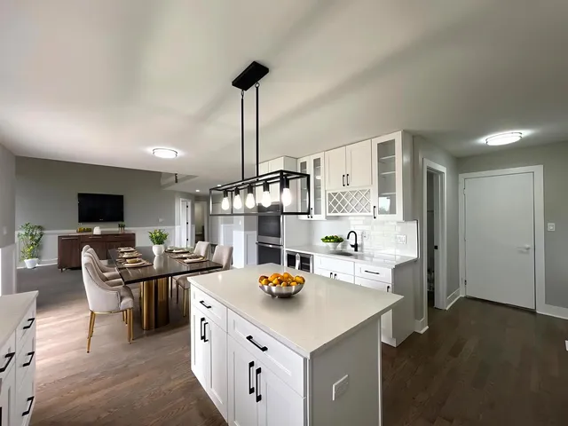 a kitchen with counter space appliances and living room view
