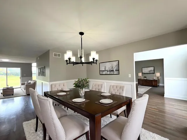 a view of a dining room with furniture wooden floor and chandelier