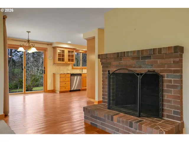 a view of a living room with furniture and a fireplace