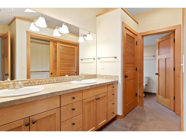 a bathroom with a tub shower and mirror