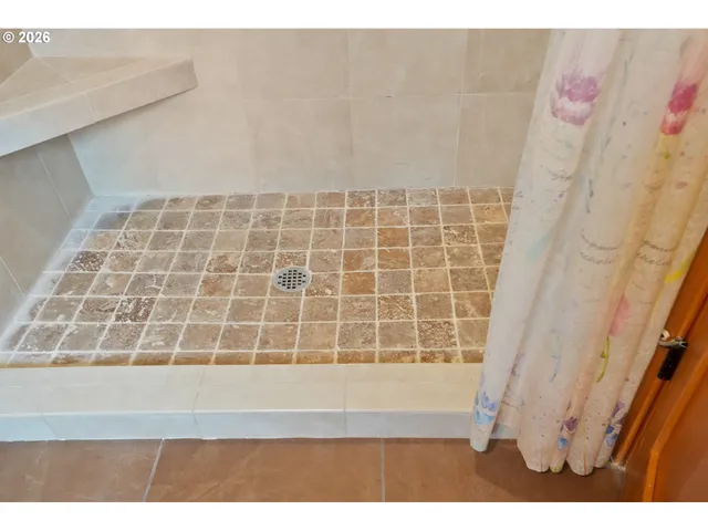 a bathroom with a sink a mirror and a shower