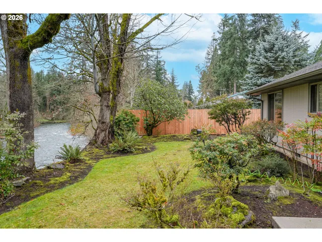 a backyard of a house with a yard and outdoor seating