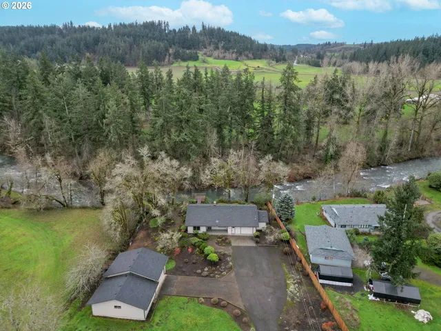 an aerial view of a house with a garden and lake view