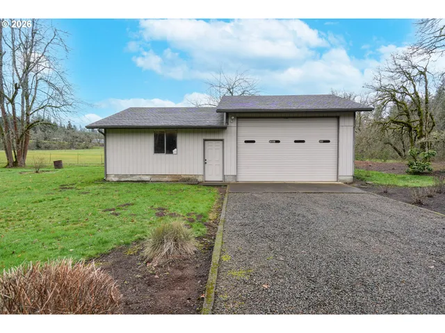 a view of a house with a yard and garage