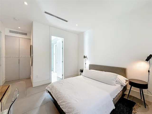 a bedroom with a bed and a lamp