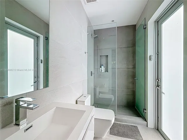 a bathroom with a sink toilet and shower