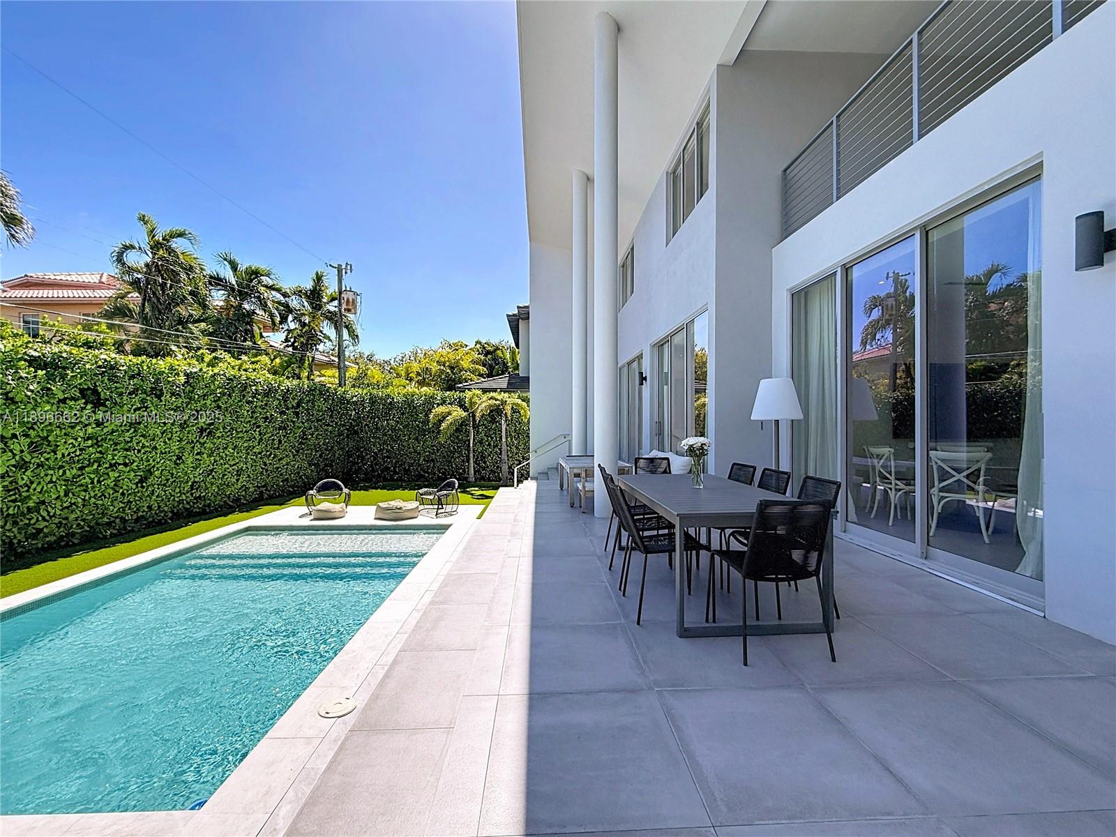 Key Biscayne Key Biscayne, FL 33149 - Photo 41 of 43 a patio with a table and chairs and potted plants