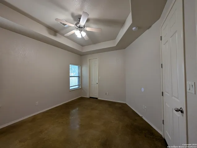 an empty room with closet and windows
