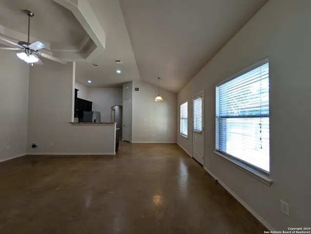 a view of a livingroom with a ceiling fan and window