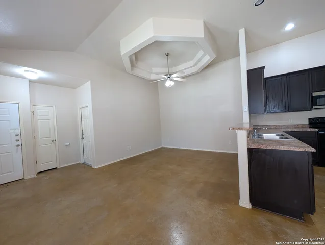a view of a kitchen with a sink and cabinets