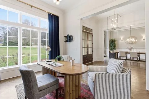 a view of a dining room with a table and chairs