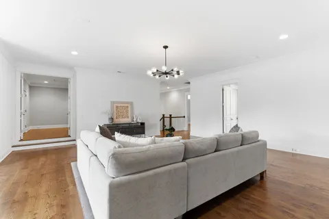 a bedroom with a large bed and a chandelier
