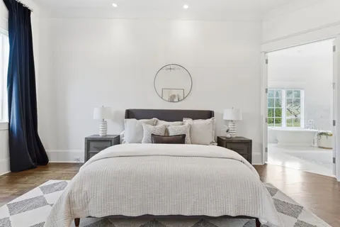 a bathroom with a sink vanity granite tub shower and a mirror