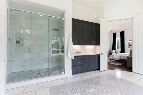 a bedroom with a bed and a chandelier