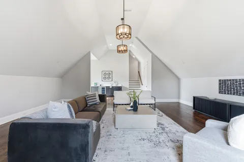 a living room with fireplace furniture and a large window