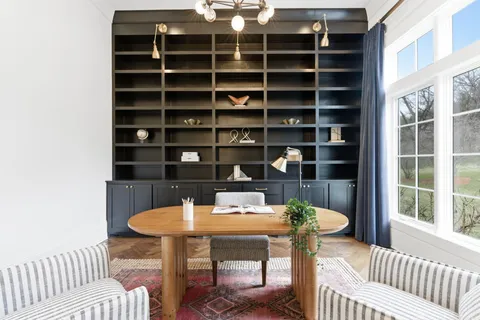 a living room with furniture a window and a table