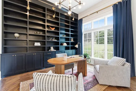 a living room with furniture and wooden floor