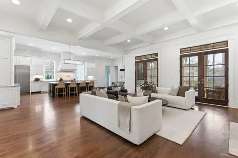 a living room with fireplace furniture and a wooden floor