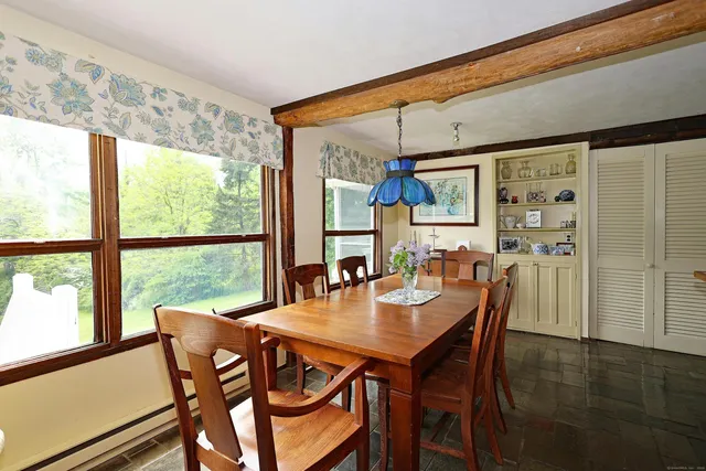 a dining room with furniture and window