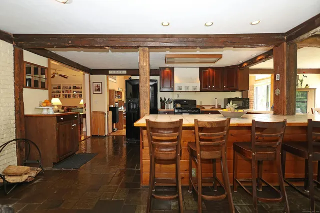 a kitchen with a dining table chairs and granite counter tops