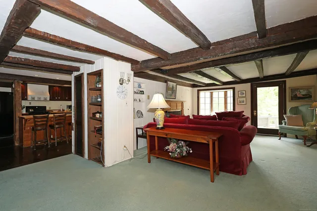 a large bed sitting in a room next to a window