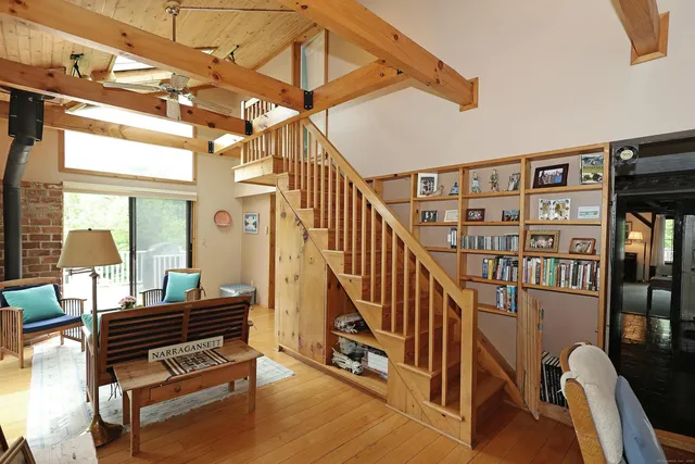 a view of hallway with stairs and wooden floor