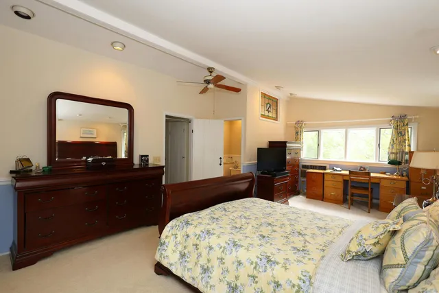 a bed room with a bed and a large mirror