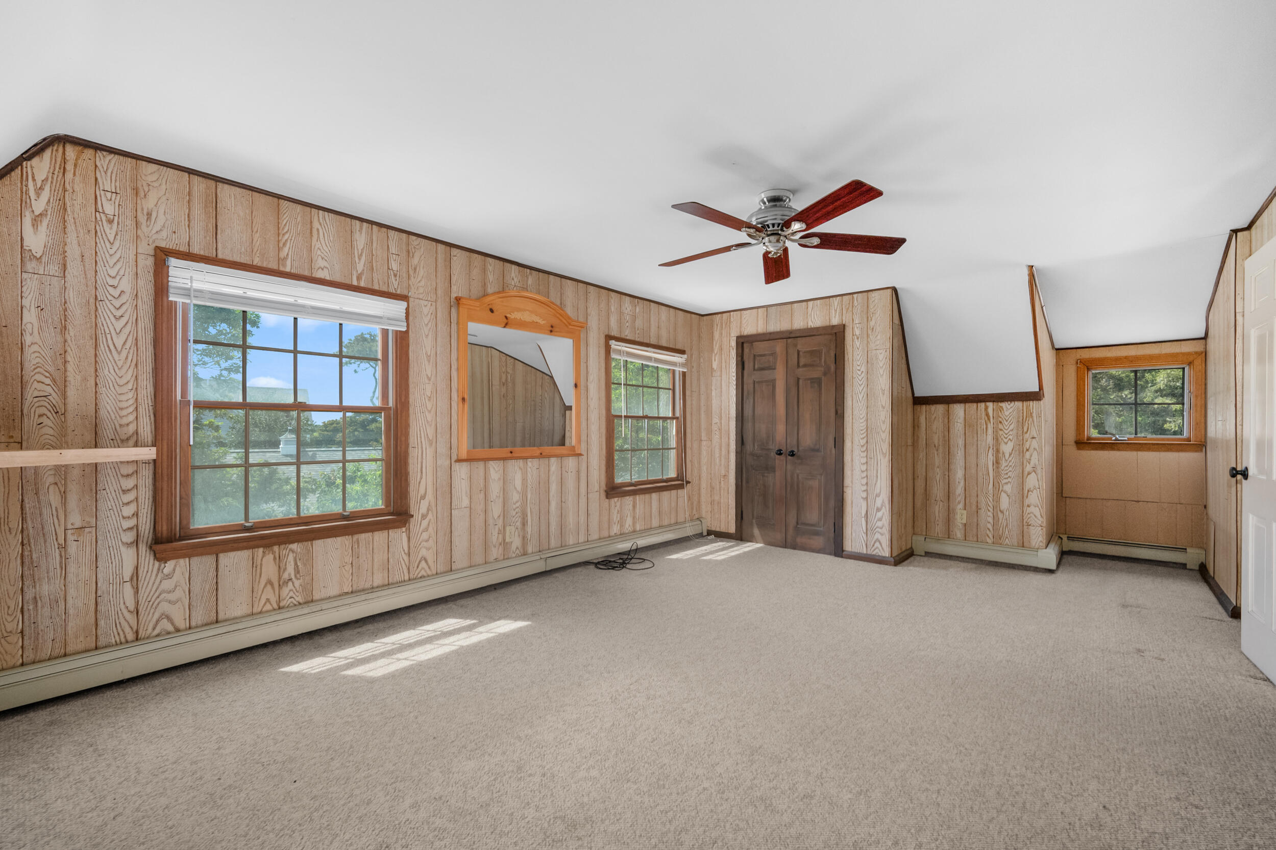 114 Bucks Creek Road Chatham, MA 02633 - Photo 20 of 43 an empty room with chandelier fan and windows