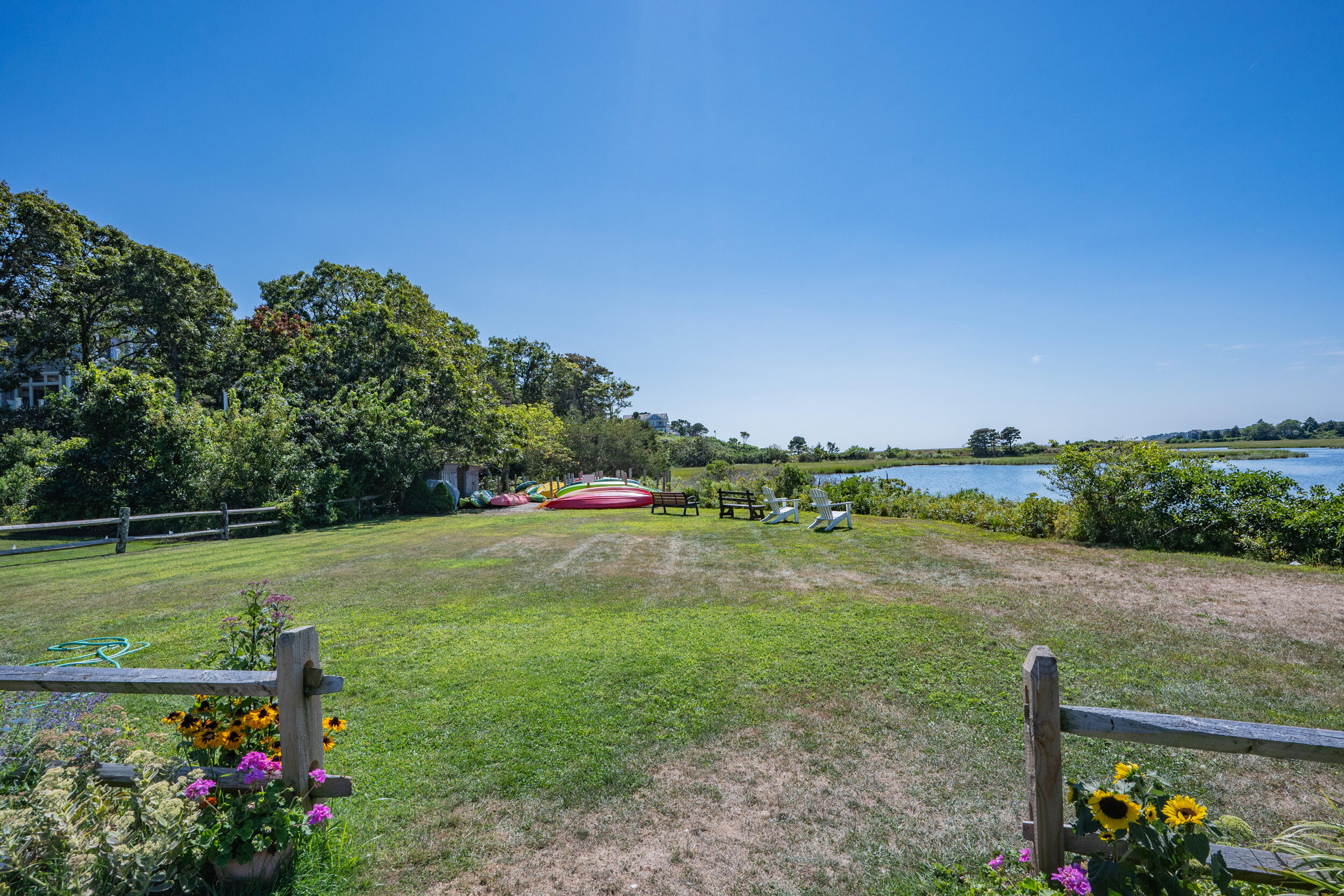 114 Bucks Creek Road Chatham, MA 02633 - Photo 34 of 43 a view of a garden with a tree in the background