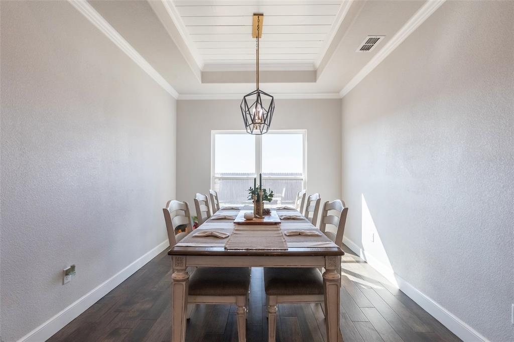 107 Kleingrass Road Abilene, TX 79606 - Photo 8 of 33 Dining area featuring wood-finish flooring, white baseboards, and neutral wall tones