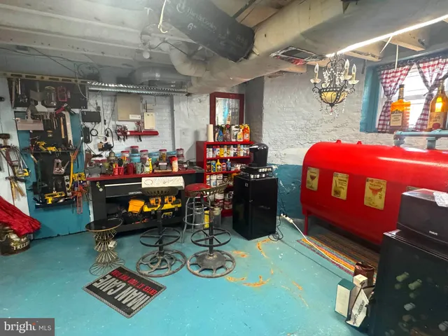 a view of a patio with table and chairs potted plants and large tree