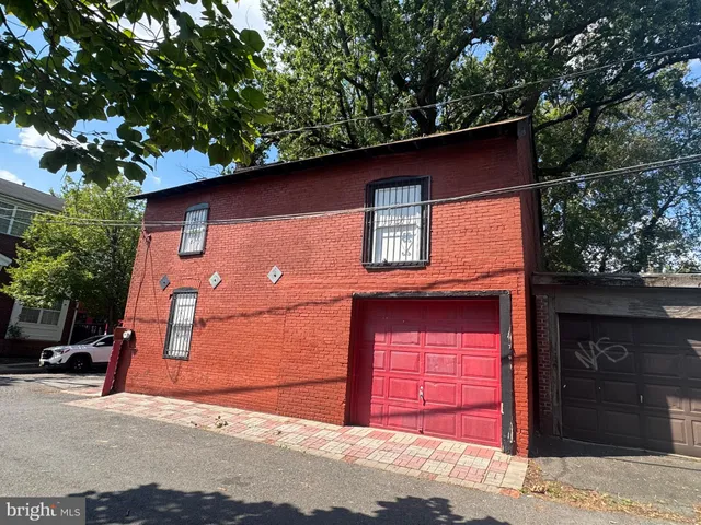 a view of a big house with a big yard and large trees