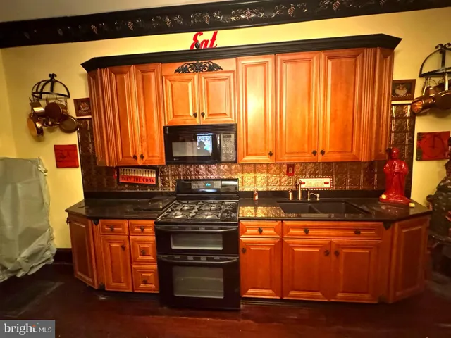 a kitchen with stainless steel appliances granite countertop a stove and a microwave