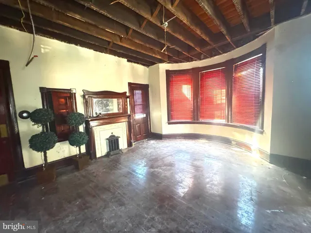 a view of an empty room with a fireplace