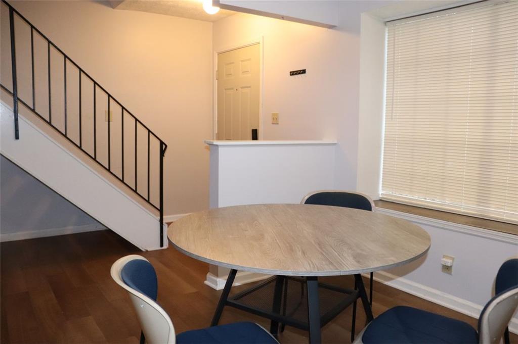 a view of a dining room with furniture and wooden floor