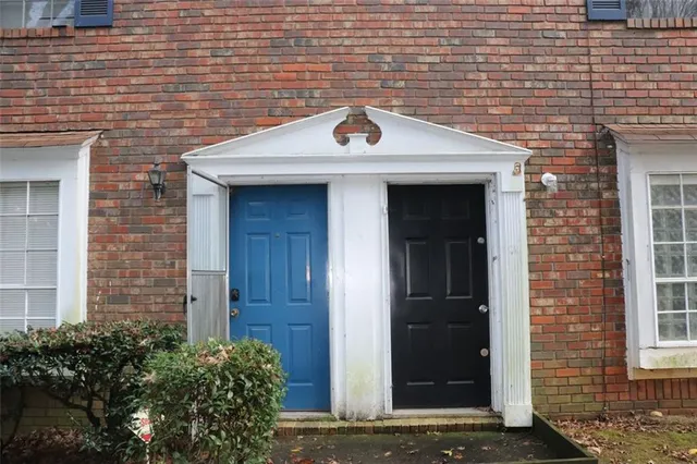 a front view of a building with a garden