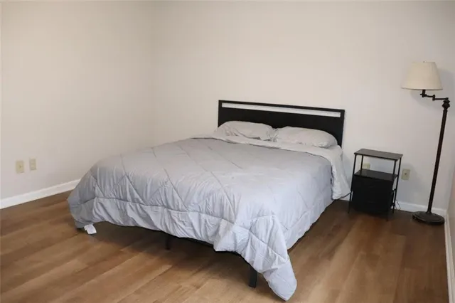 a bed sitting in a bedroom next to a wooden floor