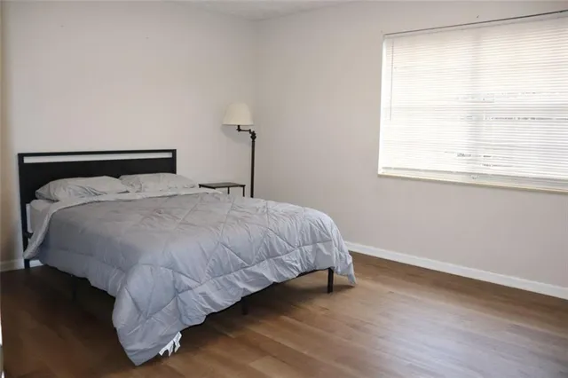 a large bed sitting in a bedroom next to a window