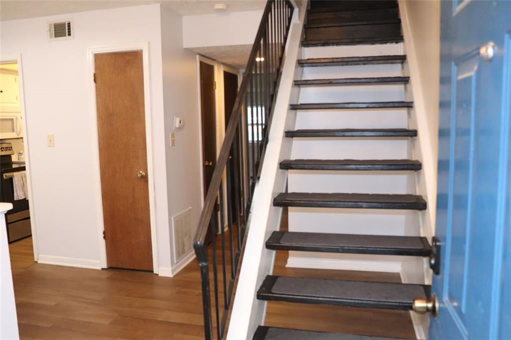 2572 Stratford Lane Morrow, GA 30260 - Photo 5 of 17 a view of staircase with wooden floor and white walls