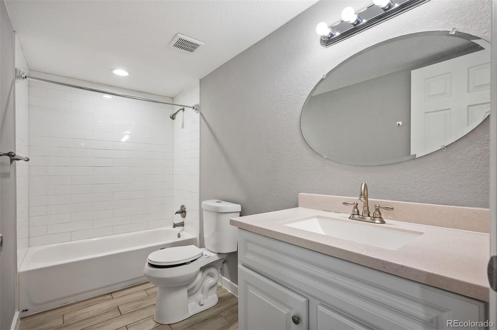 1422 Quebec Street Denver, CO 80220 - Photo 11 of 19 a bathroom with a sink a toilet and shower