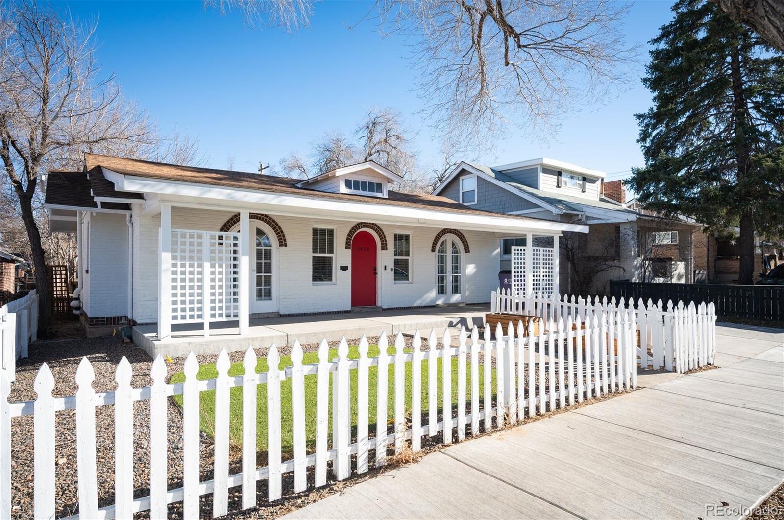 1422 Quebec Street Denver, CO 80220 - Photo 16 of 19 a front view of a house with wooden fence