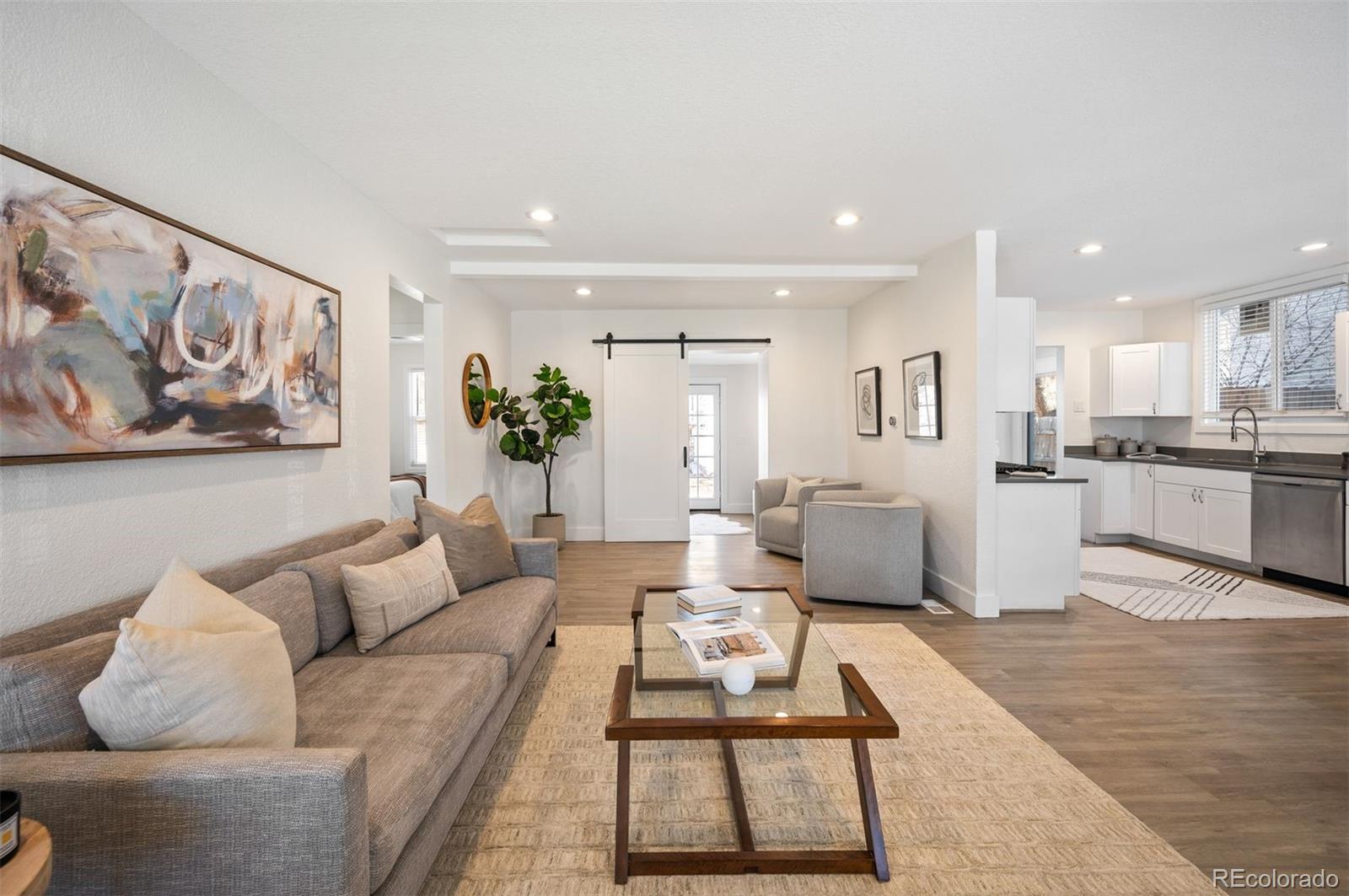 1422 Quebec Street Denver, CO 80220 - Photo 2 of 19 a living room with furniture and a view of kitchen